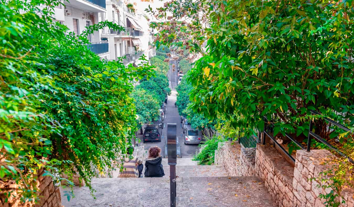 Lush greenery around a narrow walkway in the Kolonaki neighborhood in Athens, Greece