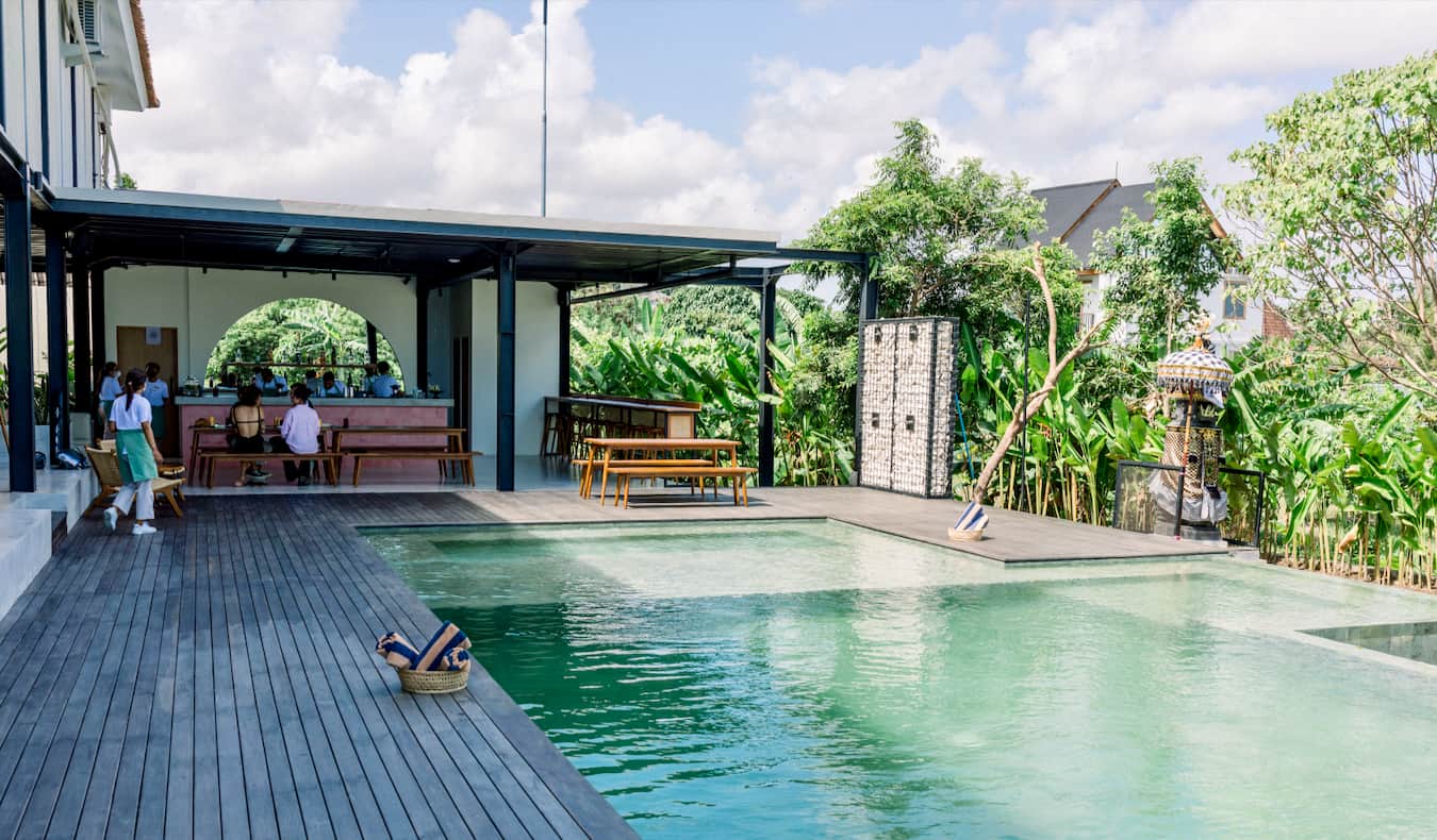 People hanging out near the pool at the Tribal Bali hostel